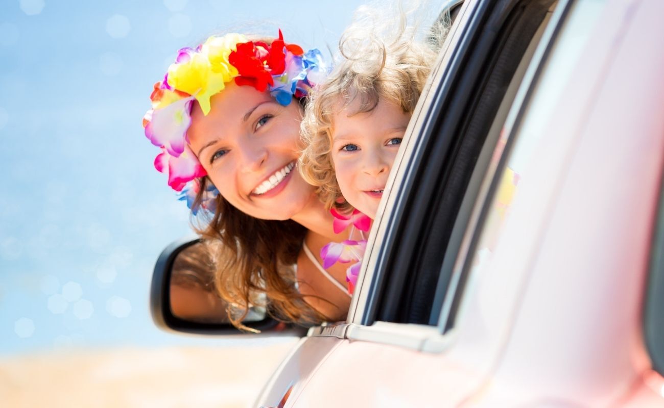 woman and child with head popping out car window