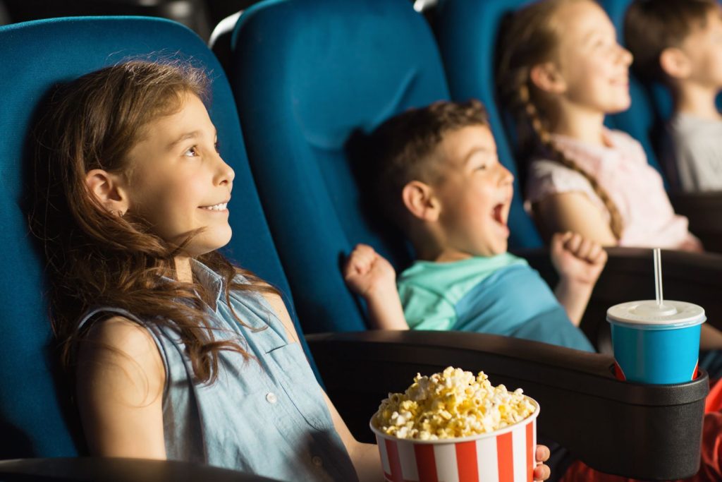Kids enjoying movie in Sarasota movie theater