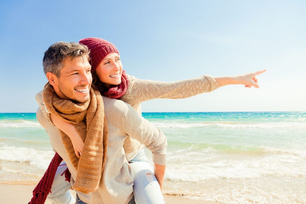 couple on the beach in winter clothes